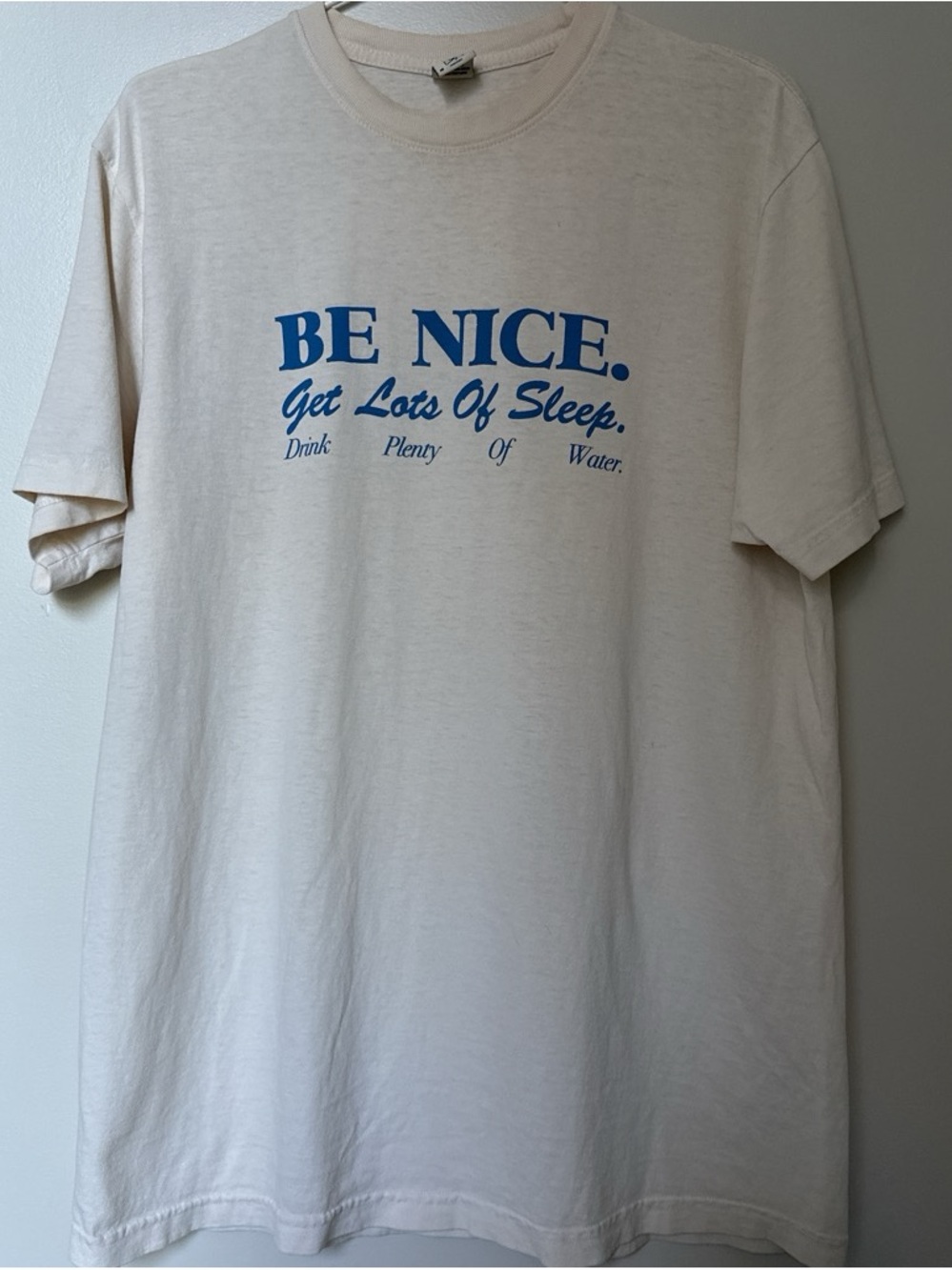Sporty & Rich Cream Tee with Blue "BE NICE" Graphic